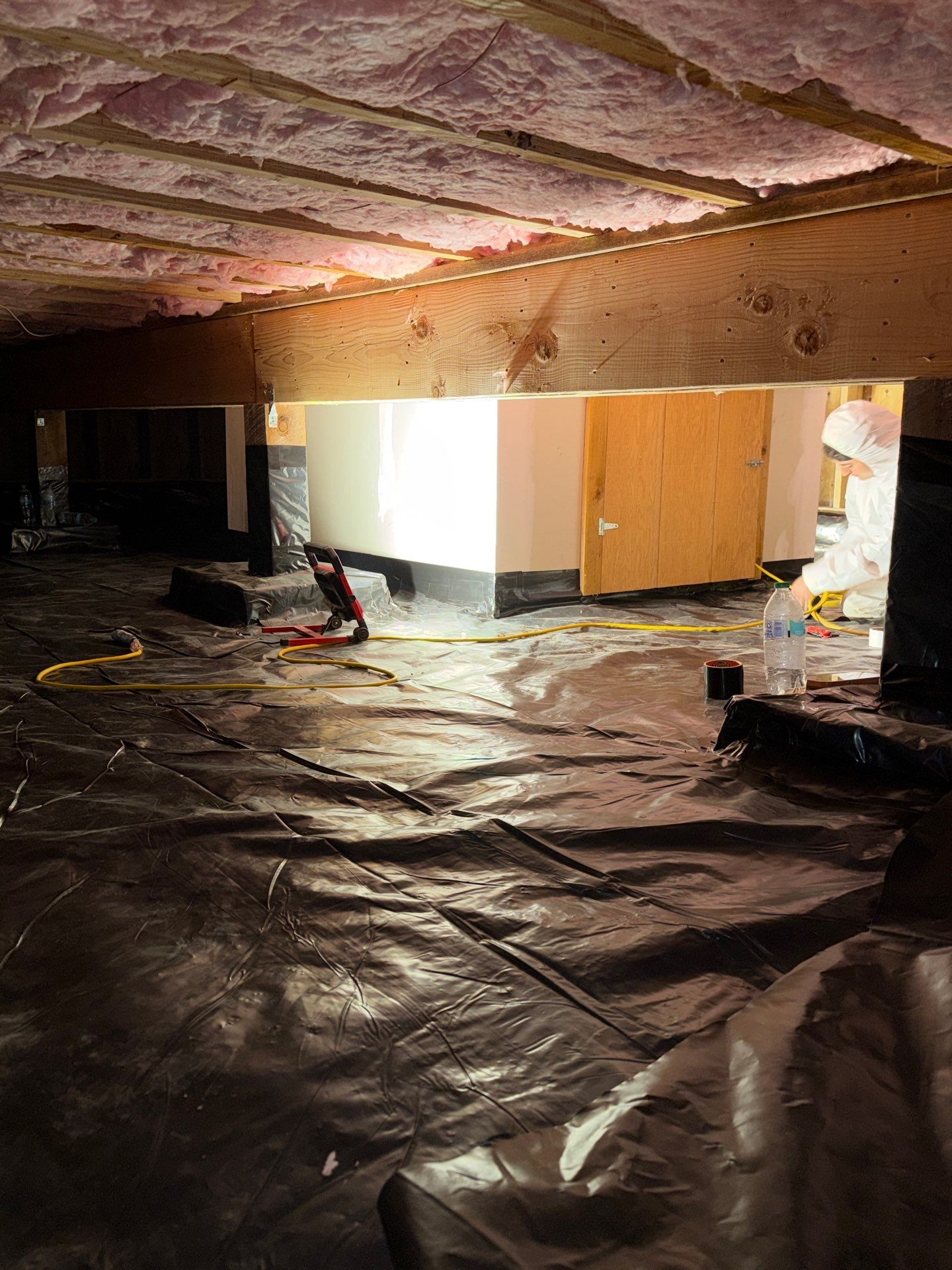 Vapor barrier sheeting laid across a crawlspace floor in Summit County Colorado